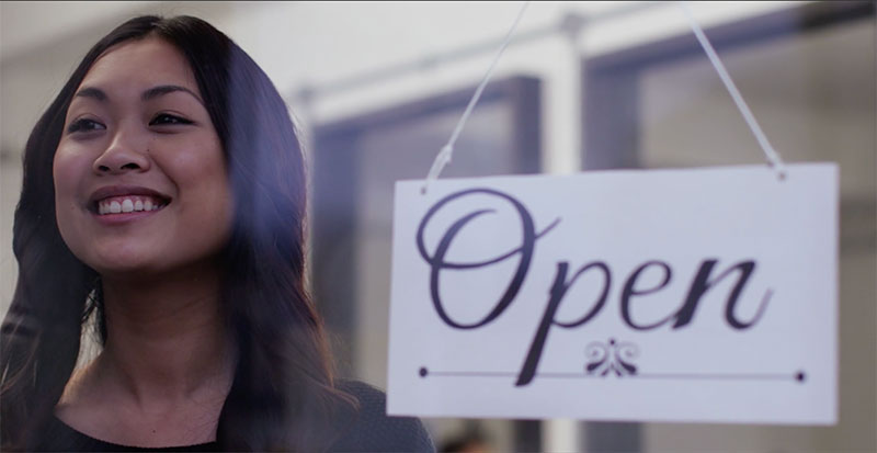 woman in front of open sign