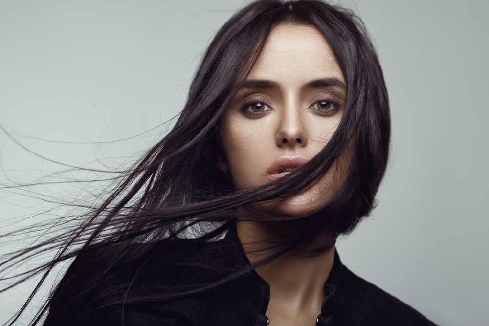 woman with dark hair flowing in front of her face