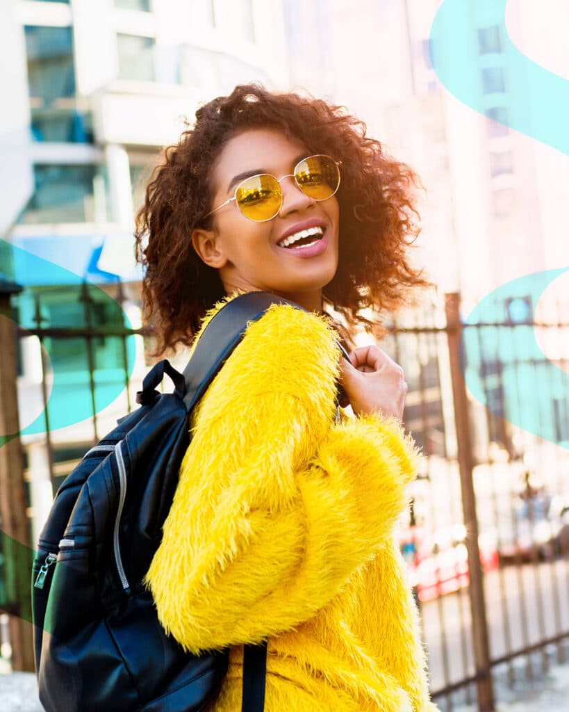 student smiling with backpack