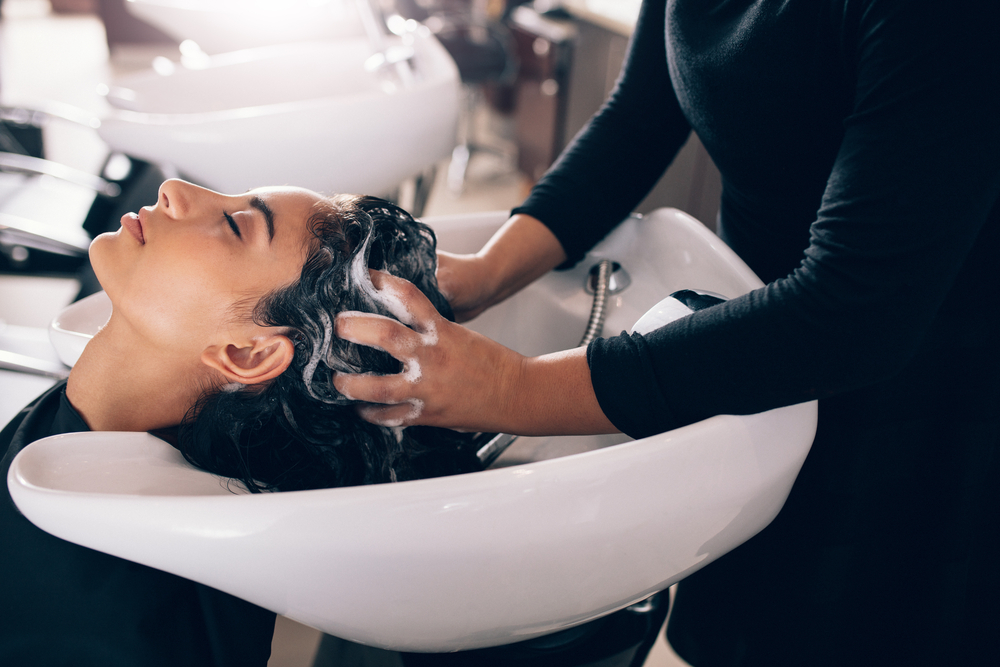 stylist washing client's hair