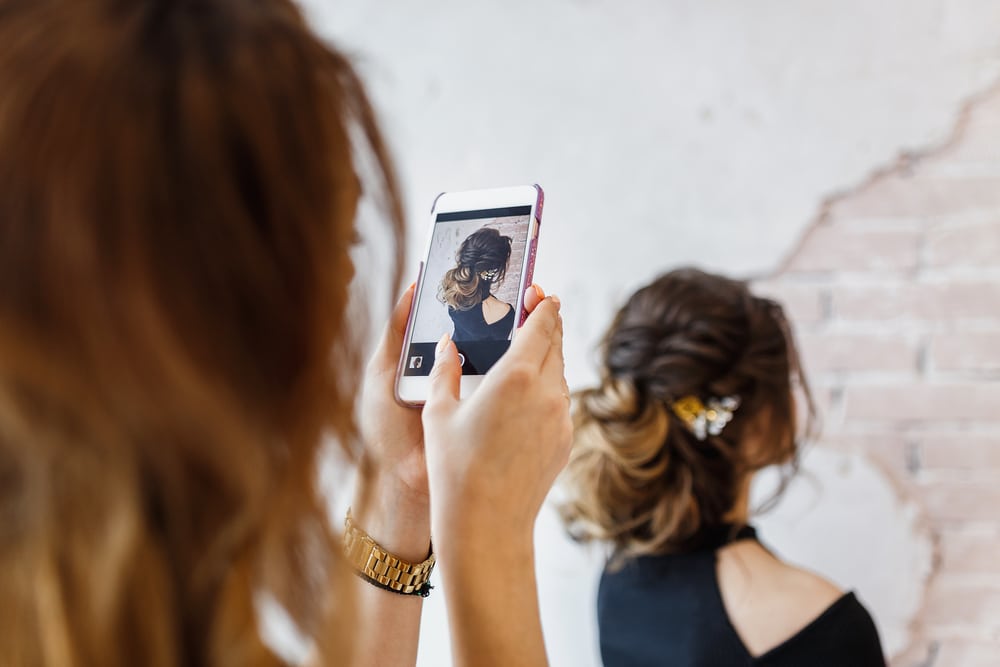 woman taking picture of hairstyle