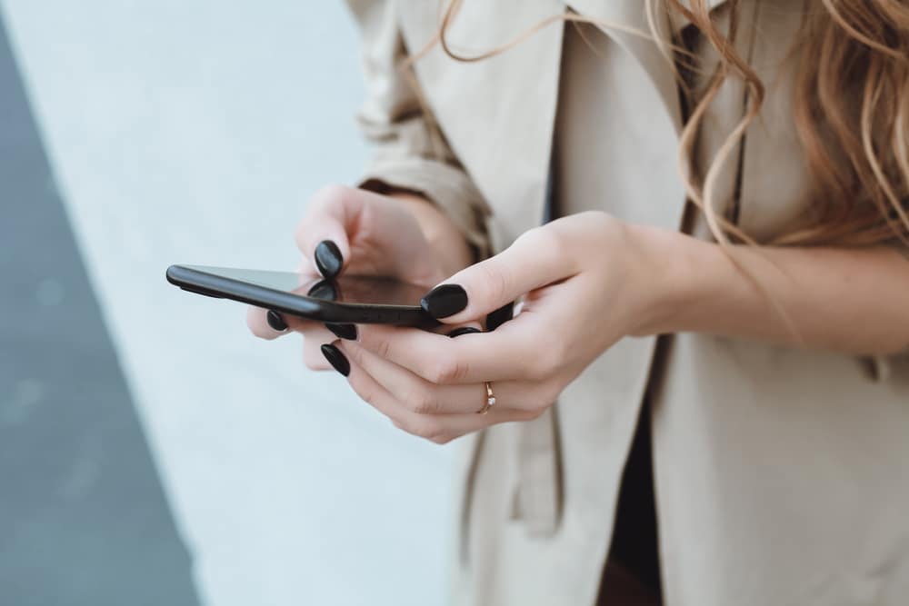 woman typing on phone