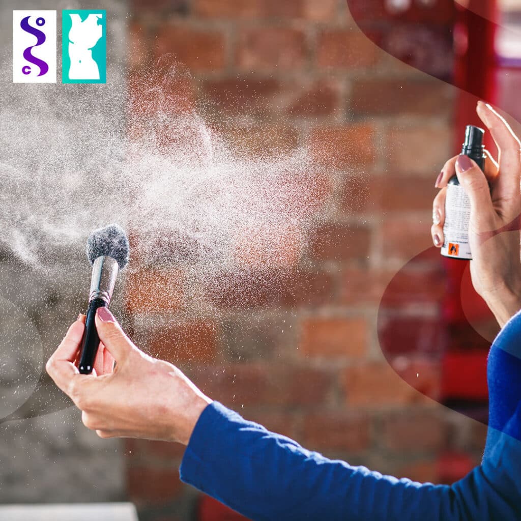 woman spraying makeup brush