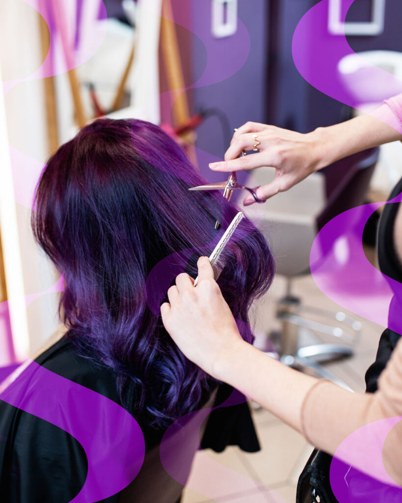 cosmetologist cutting colorful hair