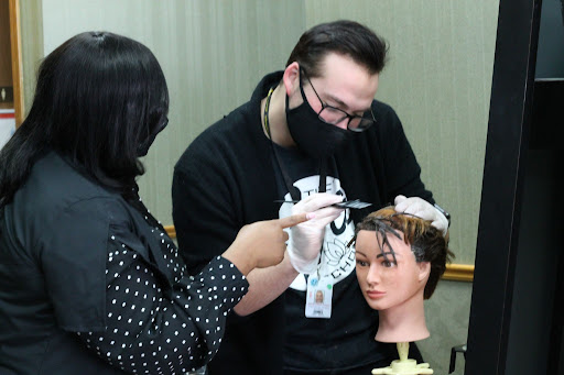 Student practicing on a mannequin with an instructor
