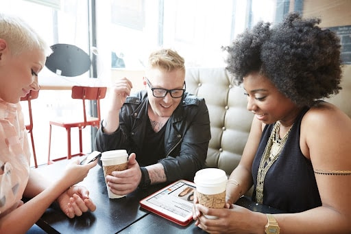 Students working together at a table with coffee